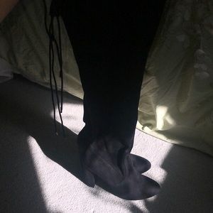 Black heeled knee high boots